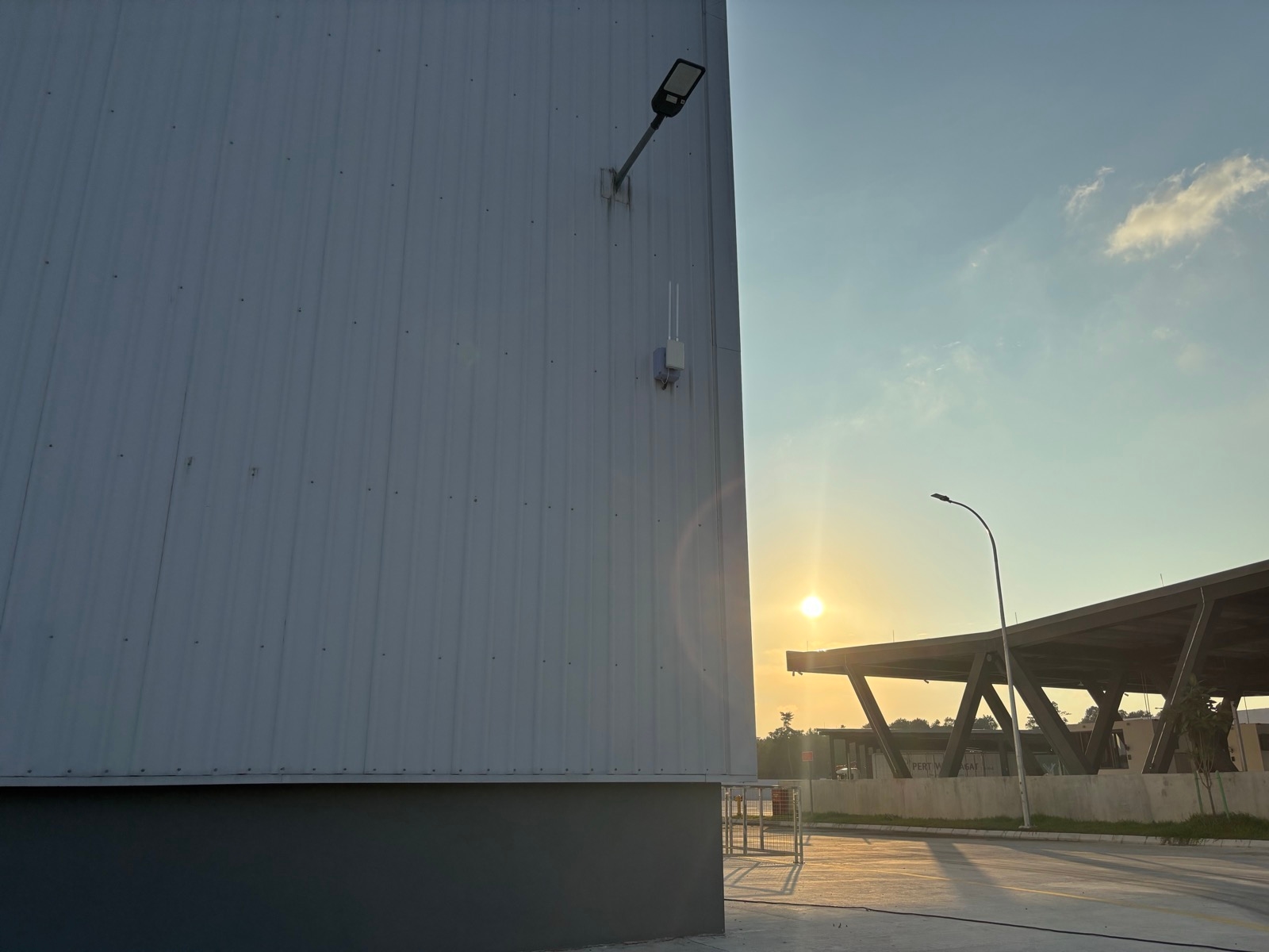 LoRaWAN gateway mounted on the exterior of a Malaysian logistics building