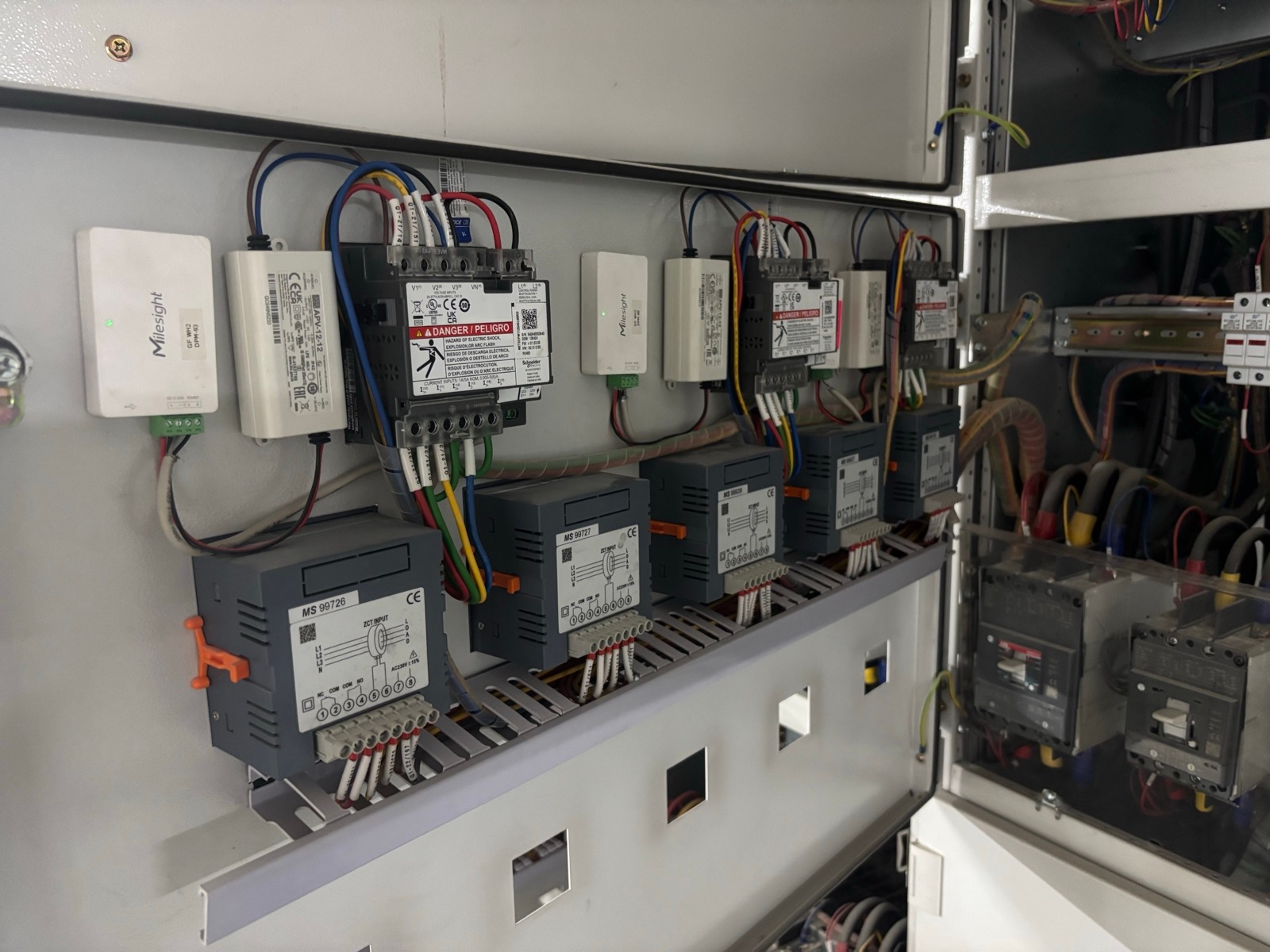 Digital power meters with Milesight LoRaWAN Modbus controllers in an electrical panel