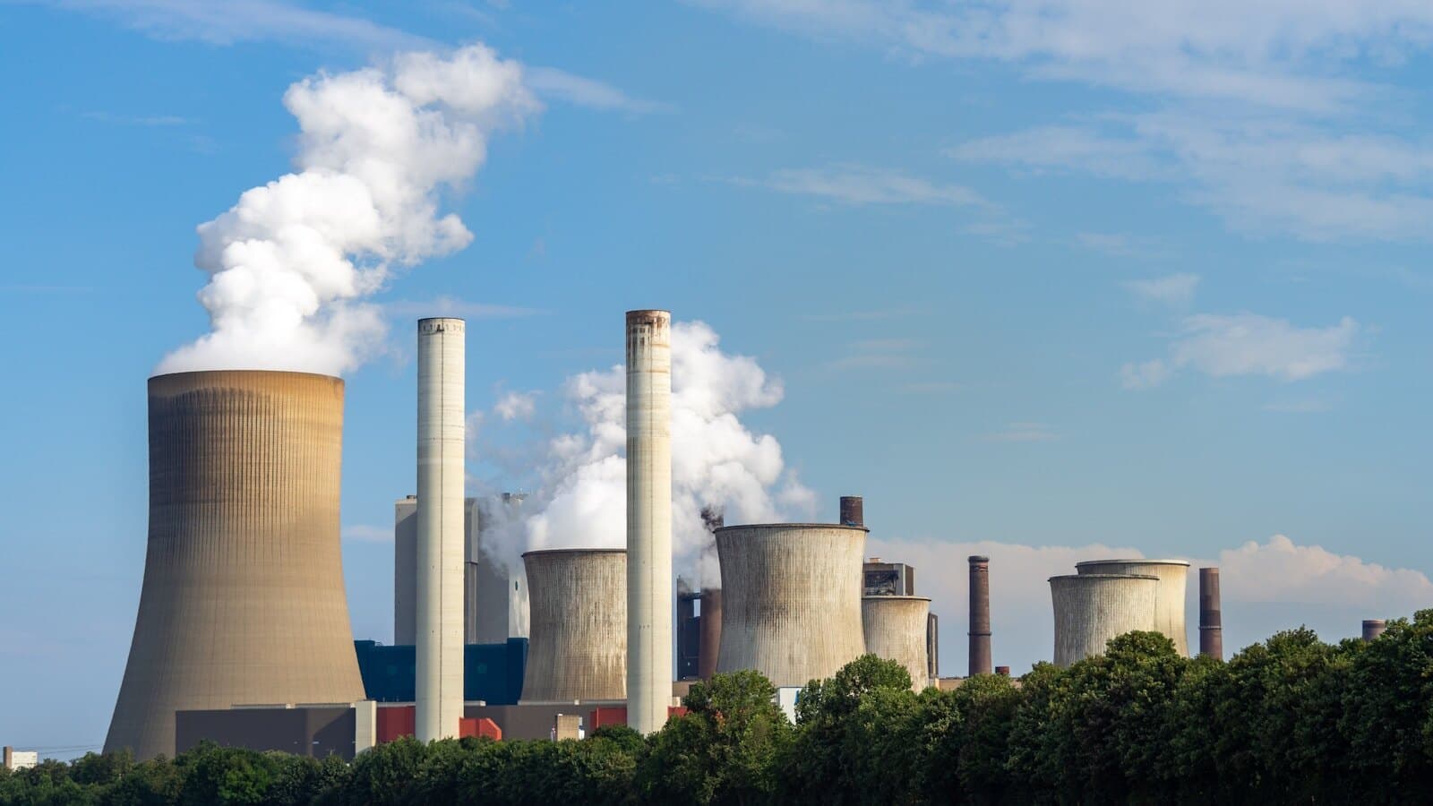 Power station cooling towers and stacks representing fuel-based electricity generation cost