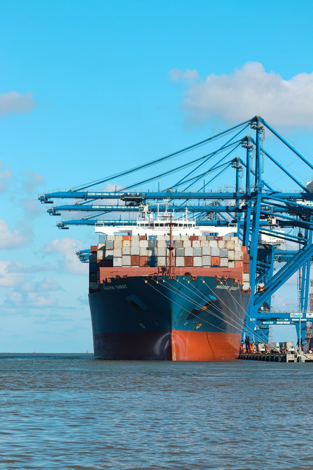 Container ship loading at a port, representing Malaysian exports to the EU