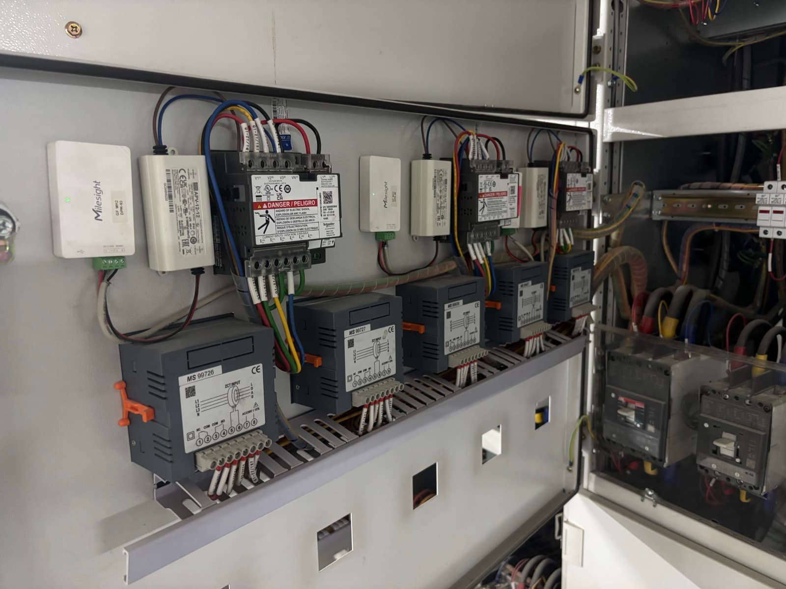 Digital power meters with Milesight LoRaWAN Modbus controllers in an electrical panel