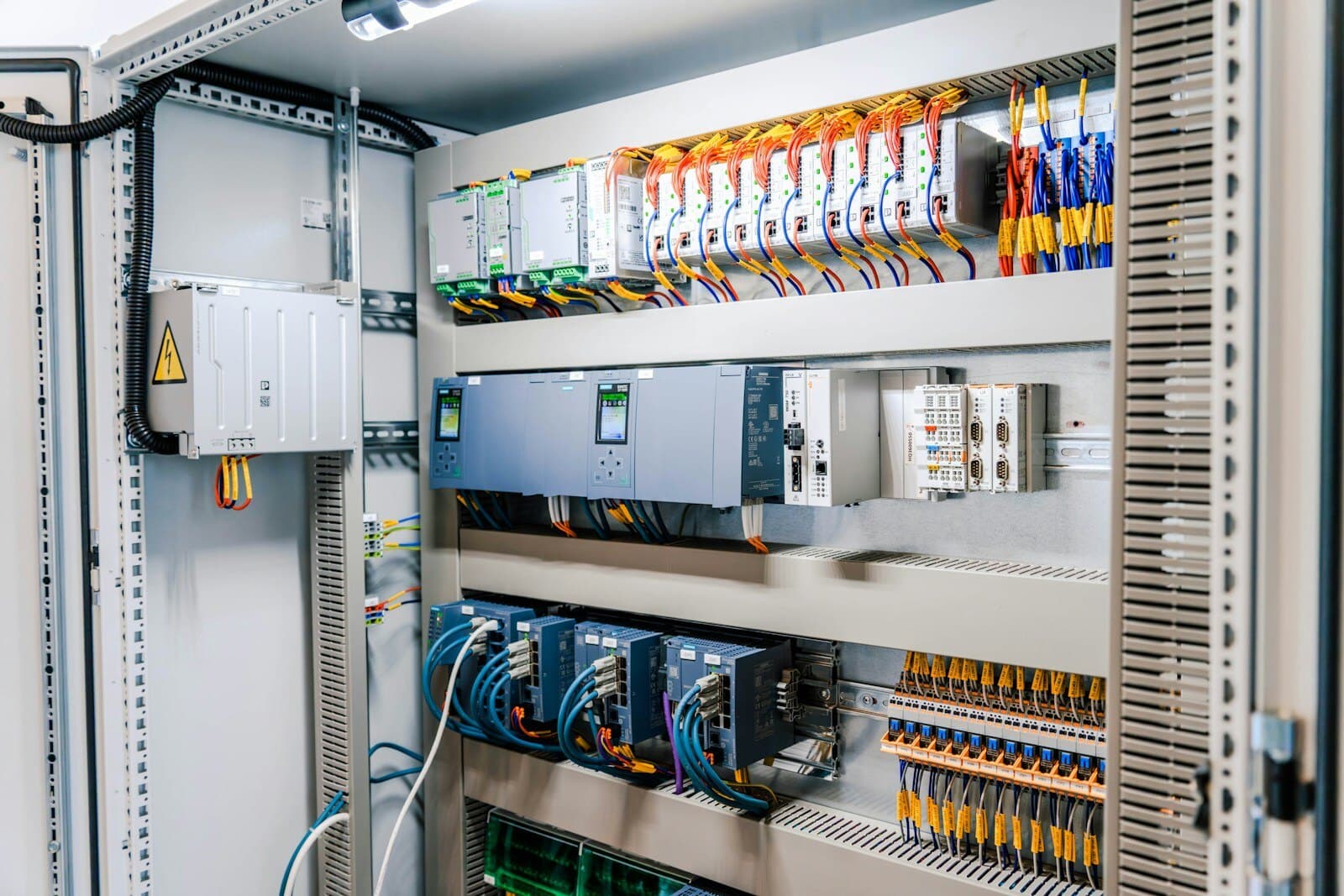 Industrial control panel with PLC modules and structured field wiring