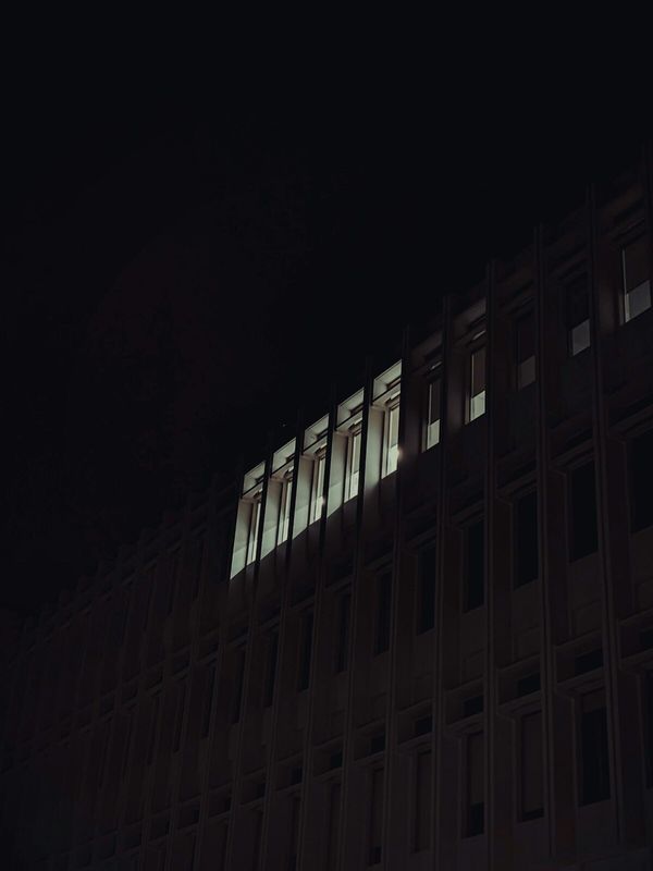 An office building facade with illuminated windows at night
