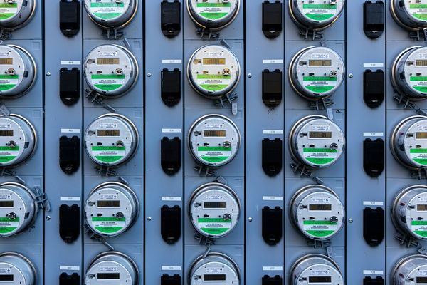 Wall of commercial electricity meters representing maximum demand billing